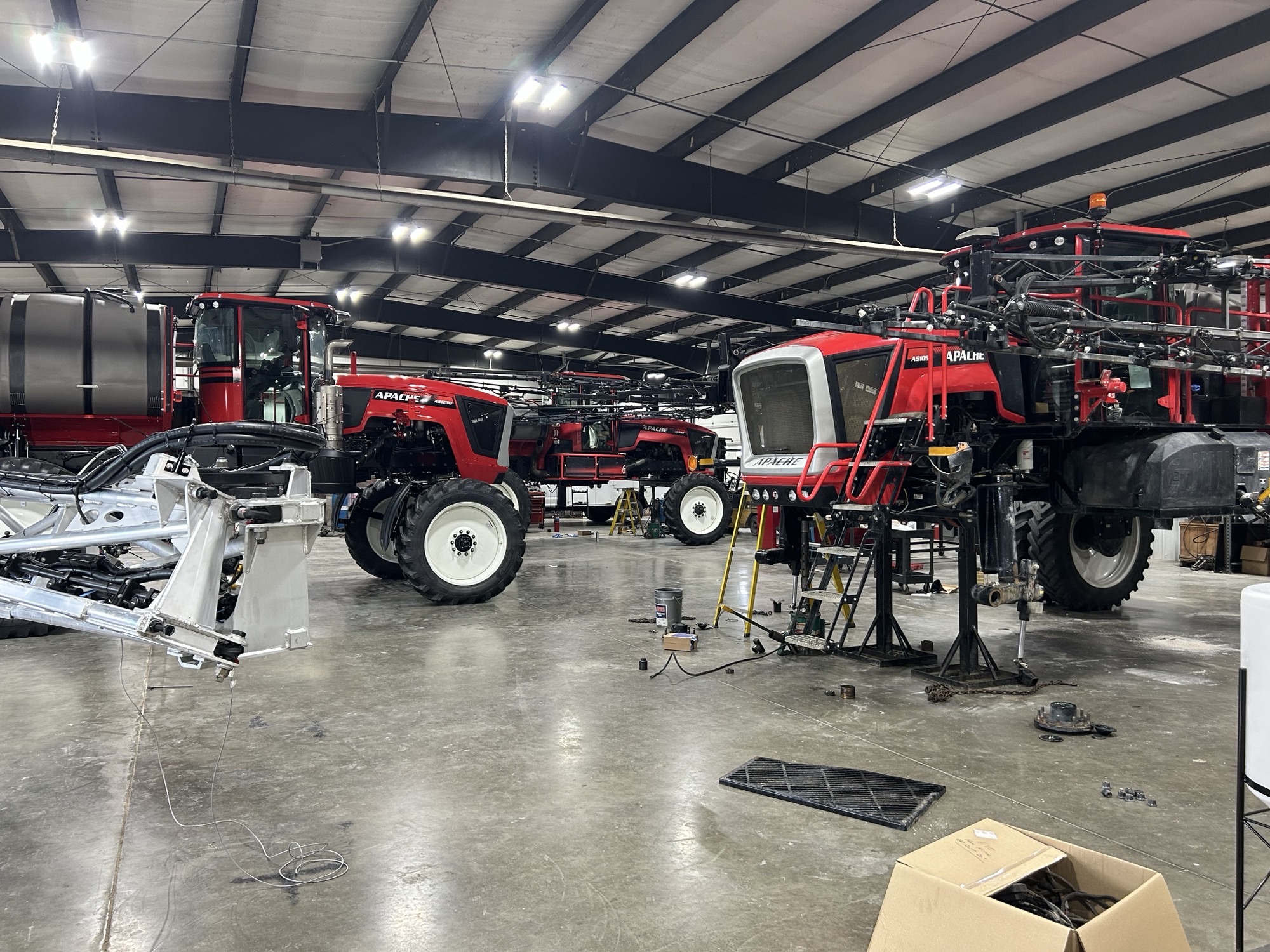 Warehouse of apache sprayers being serviced