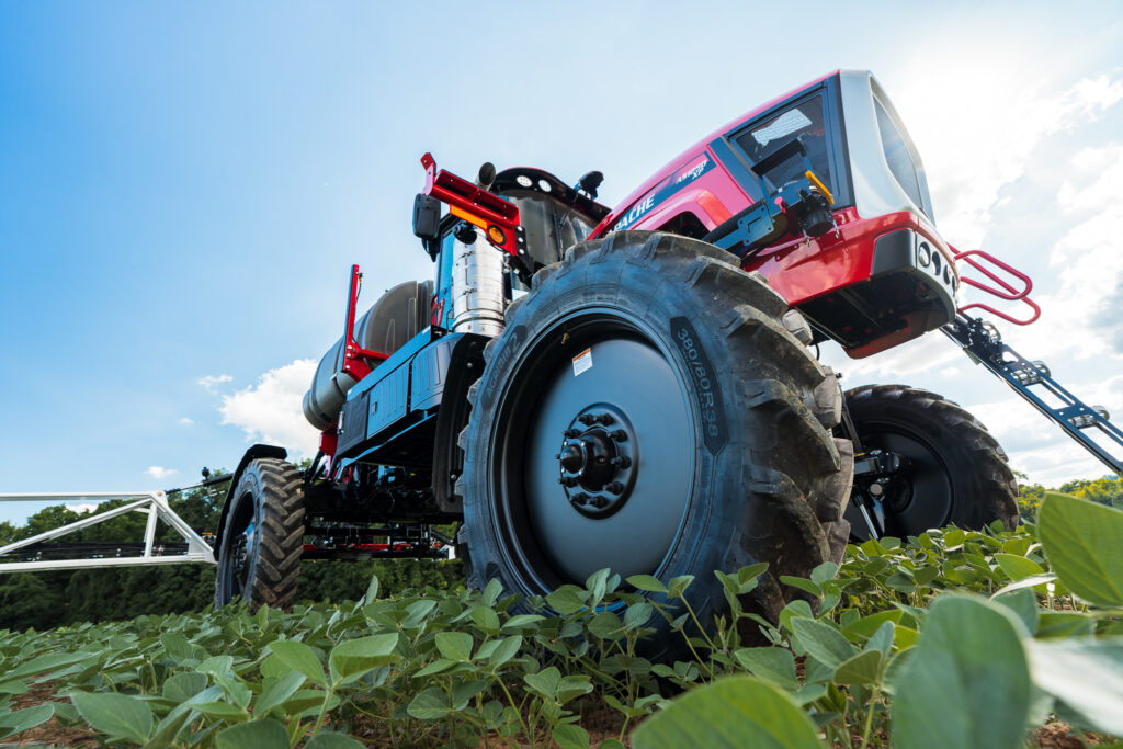 shot looking up of apache sprayer with front wheel in foreground