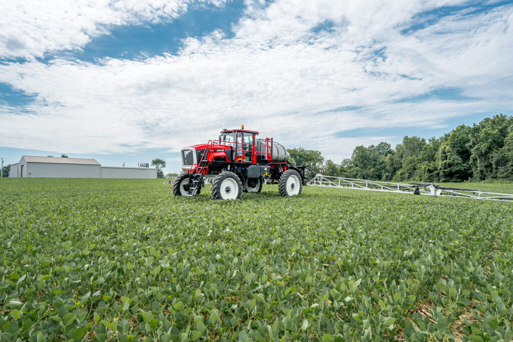 apache sprayer in field with booms extended