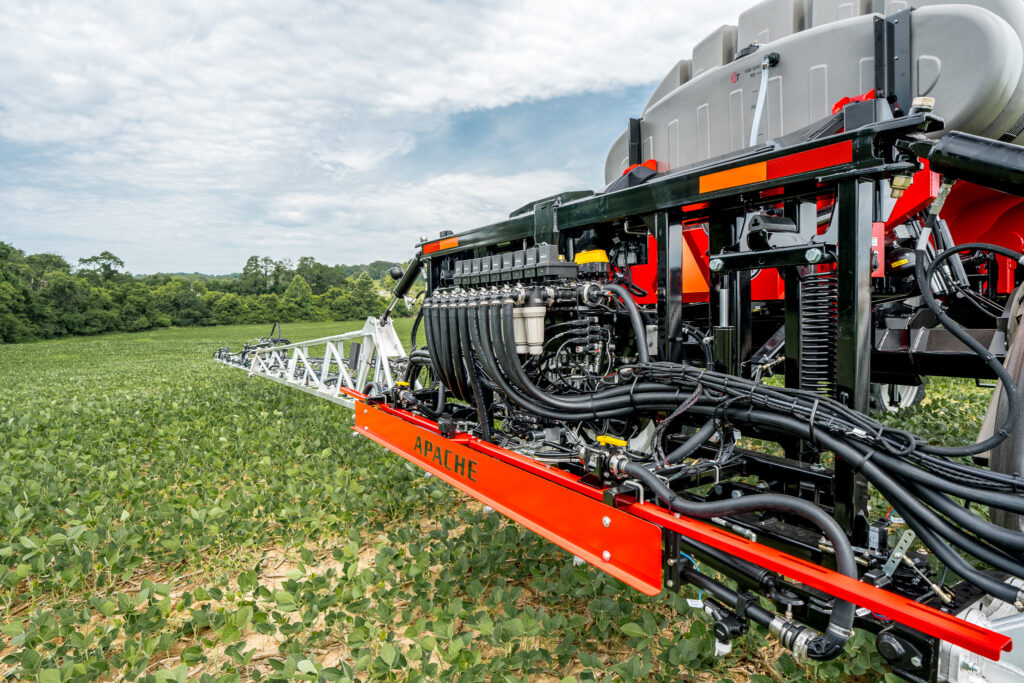 back of apache sprayer close up of hoses extending to booms